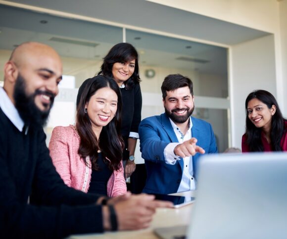 HHL full-time MBA group of students aroundlLaptop