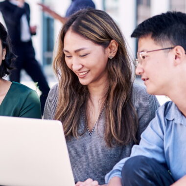 International Student Group looking at a Laptop.