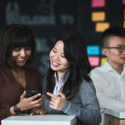 2 international female MBA students talking about something