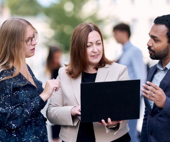 part time mba student group looking at a laptop