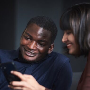 Two Mba students at HHL looking on a Smartphone