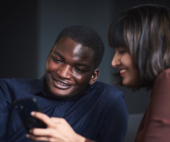 Two Mba students at HHL looking on a Smartphone