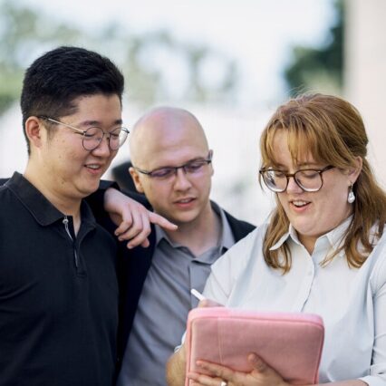 Mba Student Group looking at a Laptop.