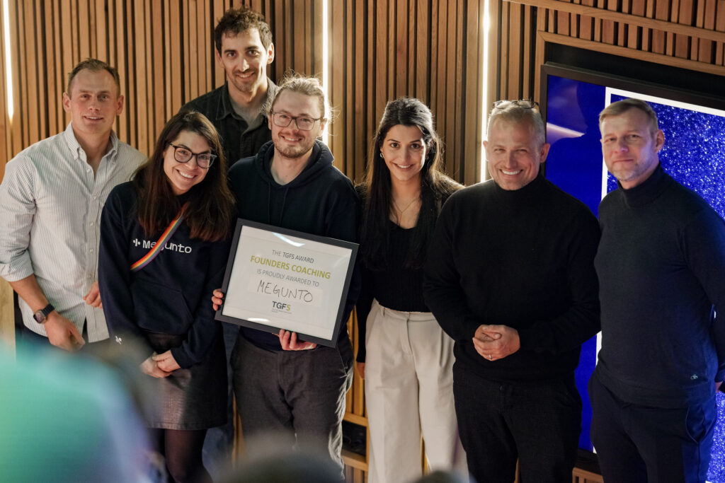 Participants holding a certificate at the end of a program session.